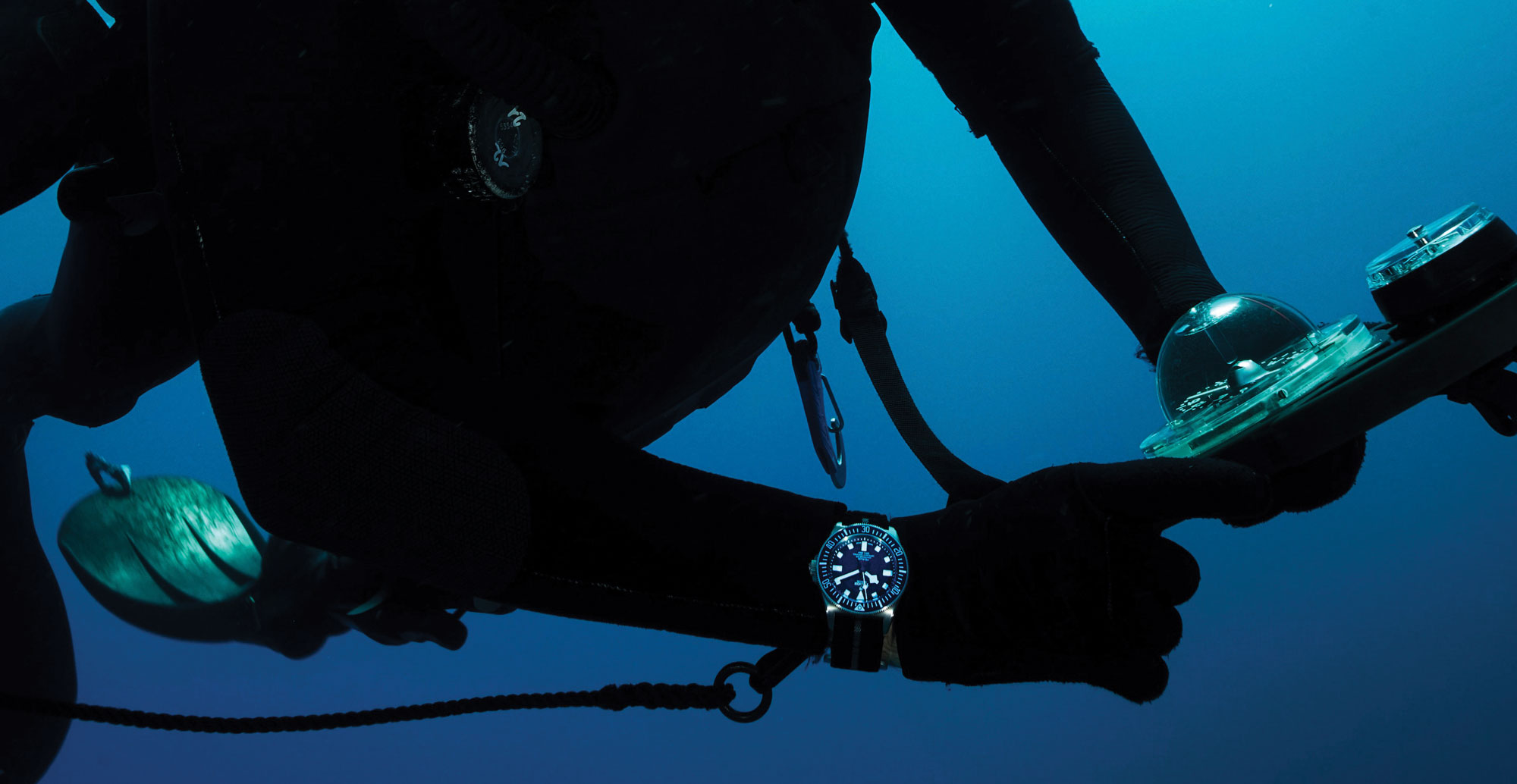diver wearing tudor watch
