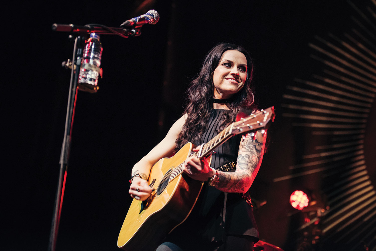 woman singing with guitar